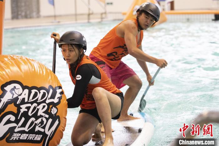 图为参赛选手在泳池内比拼技巧与速度。　董观生 摄